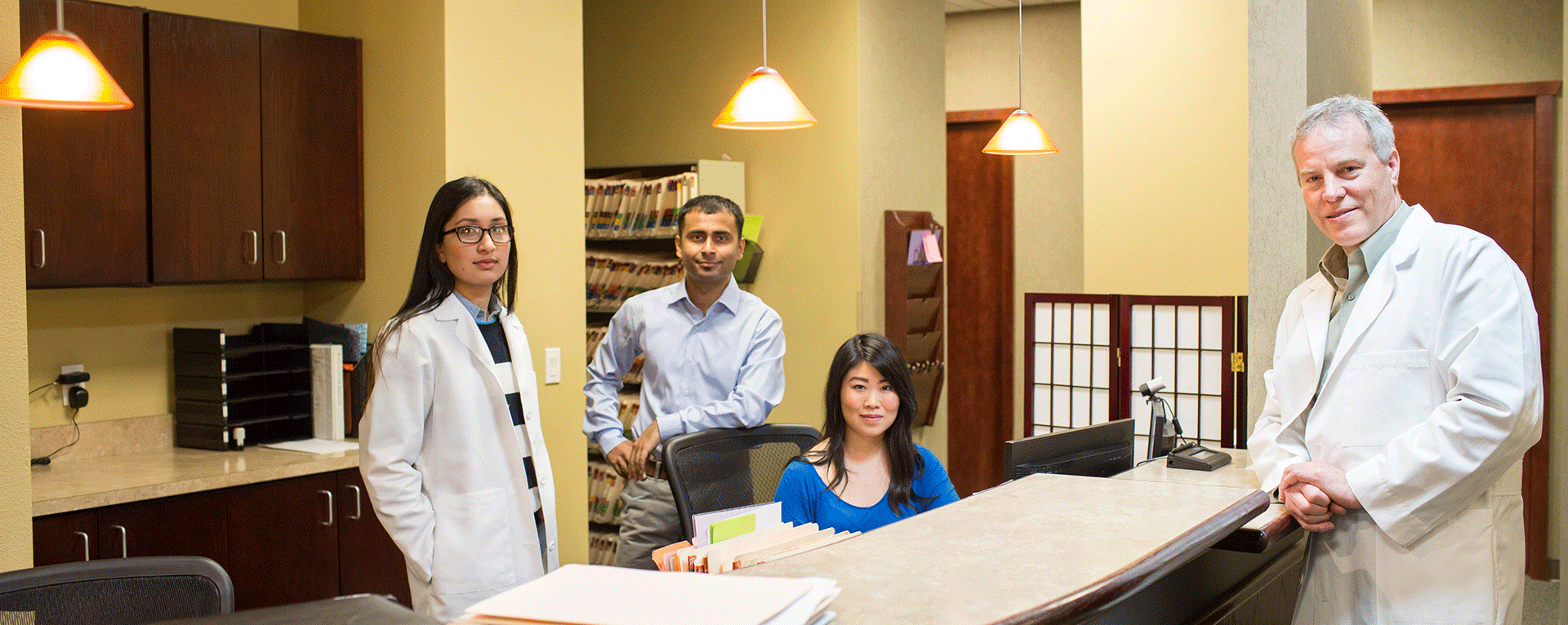 Dr Deborah Blades smiling in a medical office setting with soft natural light and welcoming atmosphere text reads Expert Spine and Neurosurgical Care conveying a sense of trust and compassion